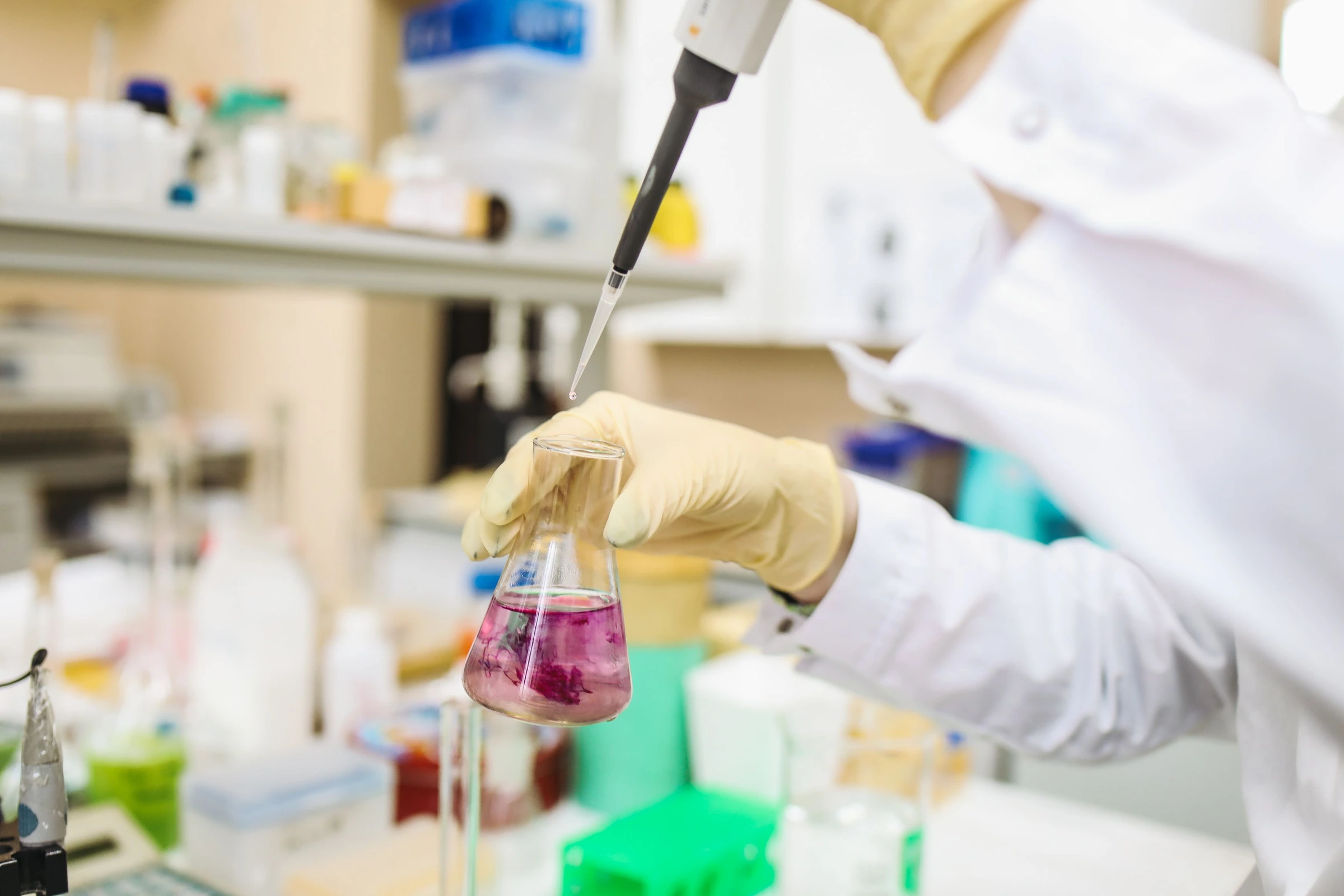 Laboratory scientist handling samples with a pipette