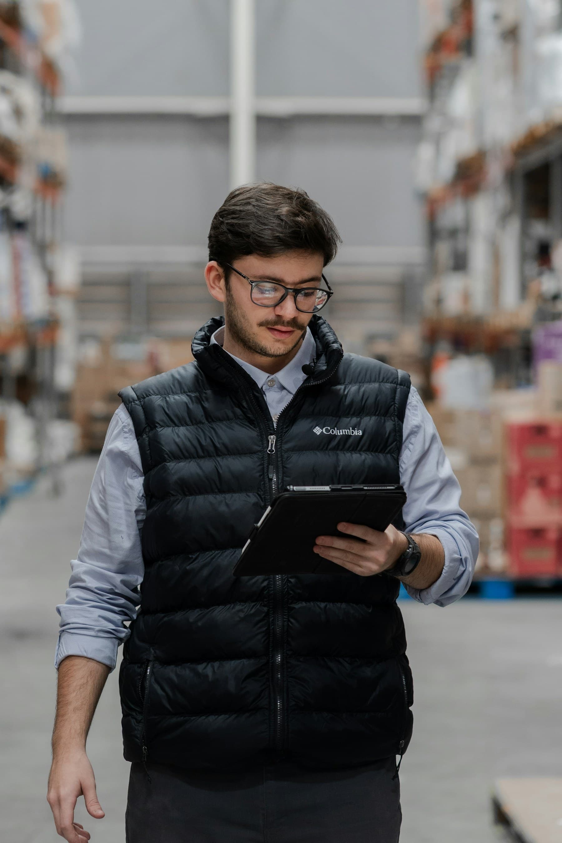 Warehouse operator checking purchase order details on a tablet